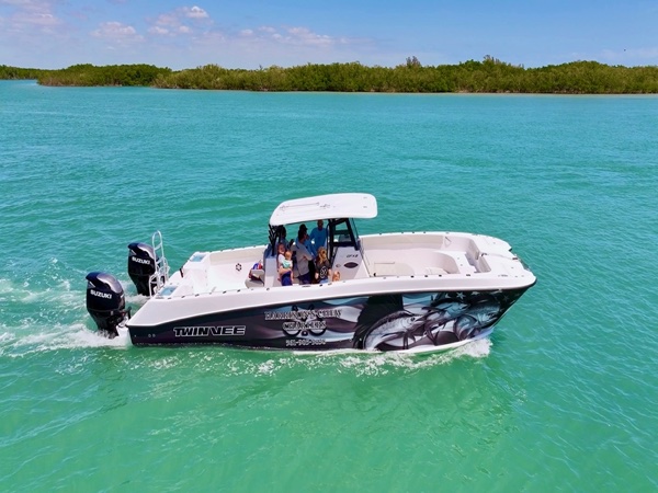 Harrison's Chew Charters offshore fishing boat on turquoise water