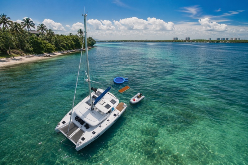Aerial view of Luna Cat anchored in turquoise water near a tropical island