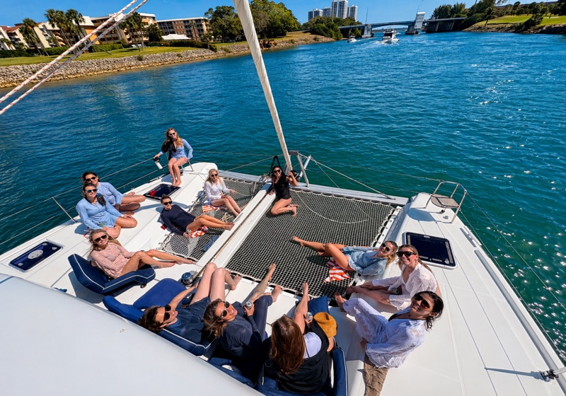 Large group of guests enjoying the bow of Luna Cat on the water
