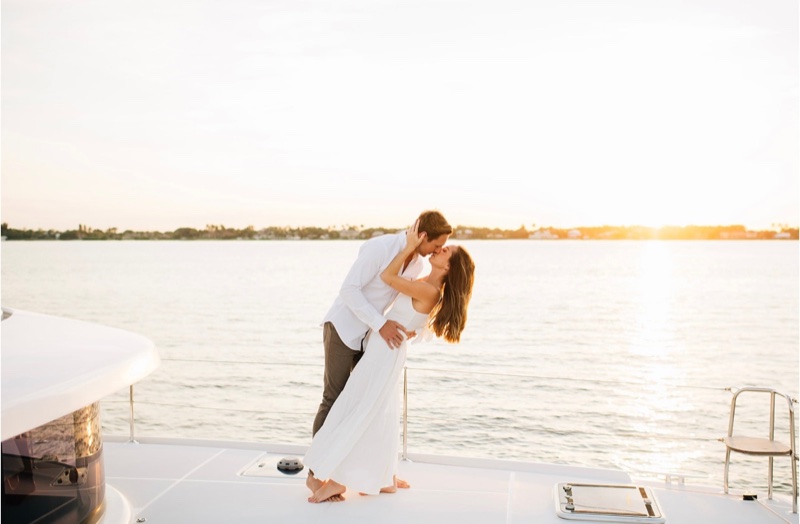 Couple sharing a kiss on the bow of Luna Cat