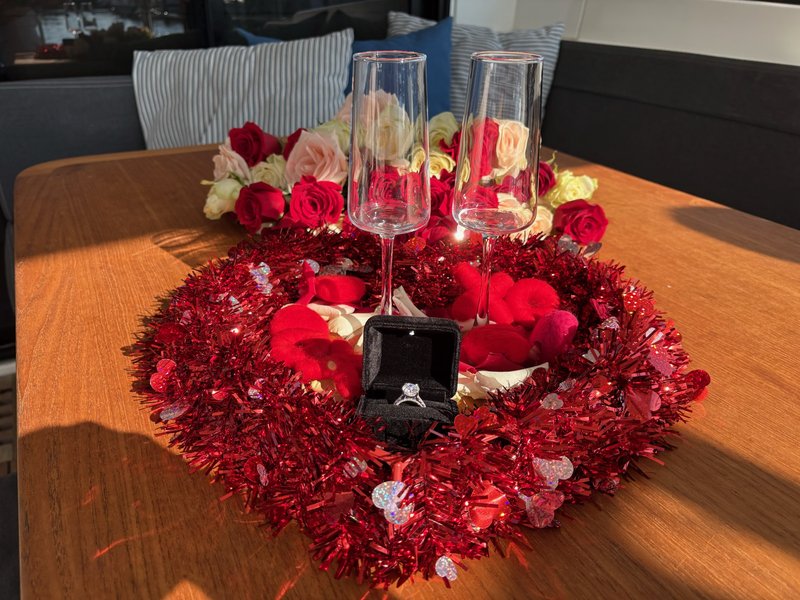 Champagne and engagement-ring setup aboard LunaCat