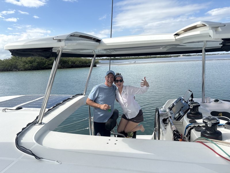At the helm of LunaCat with sandbar in the distance