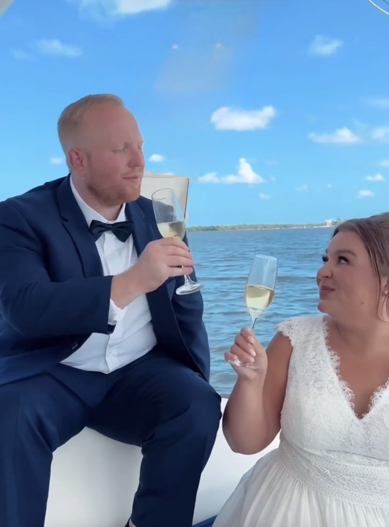 Bride and groom toasting champagne aboard LunaCat